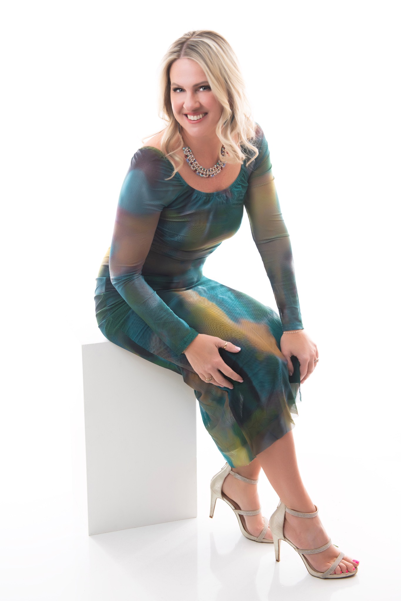 40 Over 40 participant smiling in a seated portrait